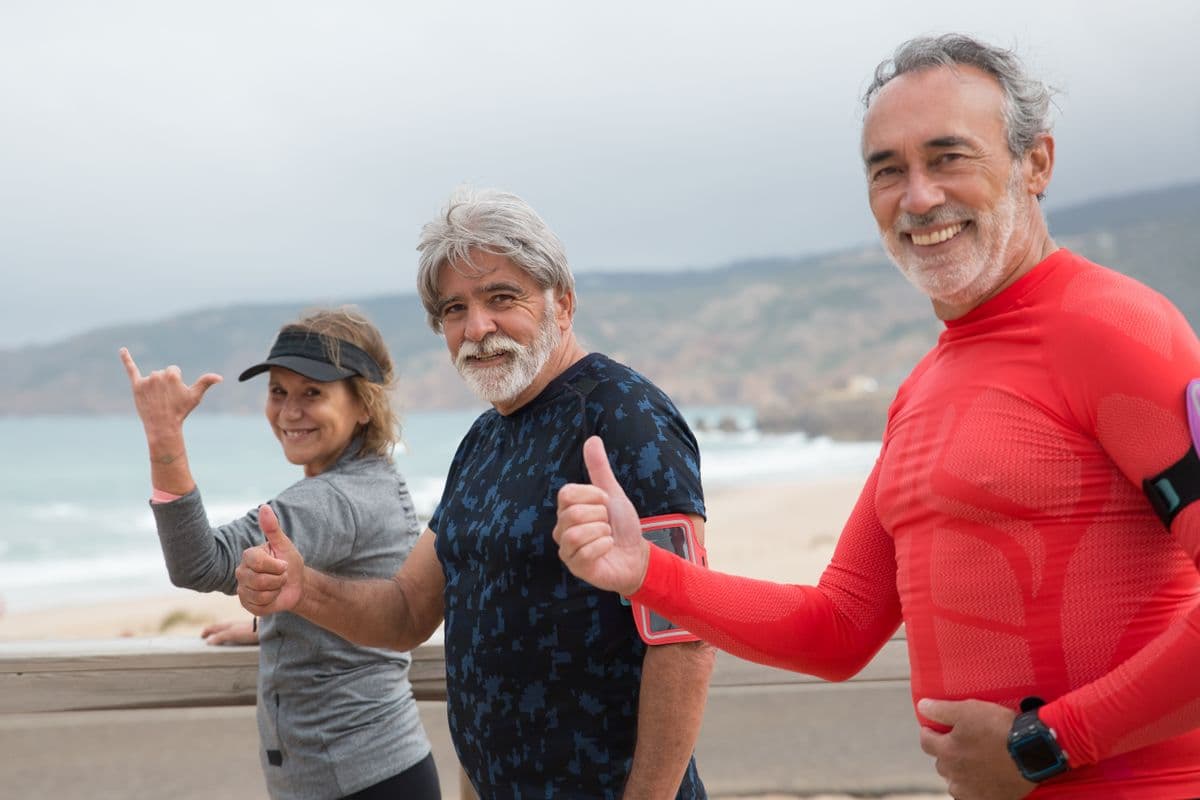 Active seniors exercising outdoors by the sea